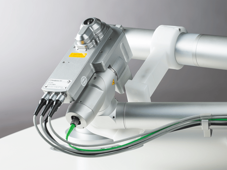 Detailaufnahme des Handstücks des FEMTO Z8-Lasers; technische Komponenten und Kabel präzise im Fokus.